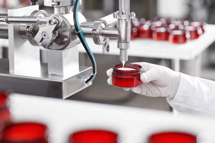 Portrait of big factory process of creating lotion for skincare.